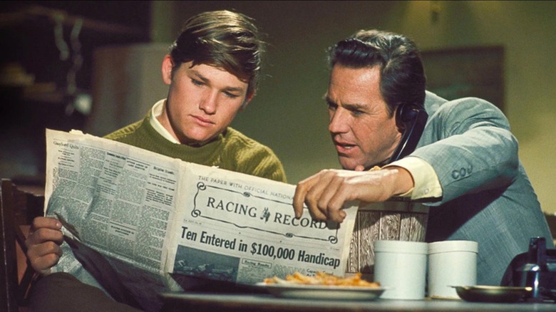 Dexter Riley and a guy on a telephone looking at a racing form in The Computer Wore Tennis Shoes