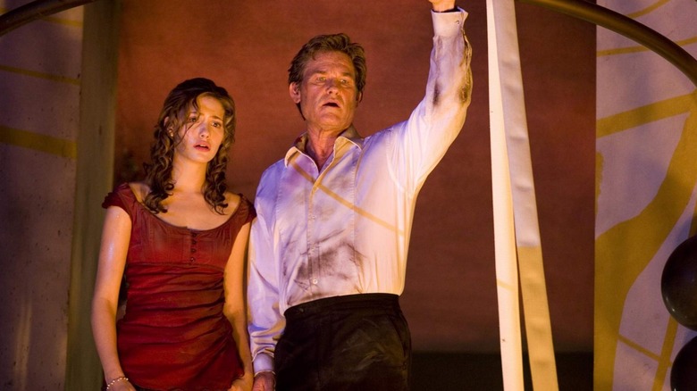 Emmy Rossum as Jennifer Ramsey standing next to Kurt Russell as Robert Ramsey as they both look down in Poseidon