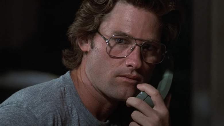 Kurt Russell as Malcolm looking alarmed while on the phone in The Mean Season