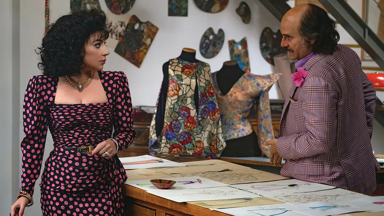 Patrizia and Paolo chatting in a workshop in House of Gucci