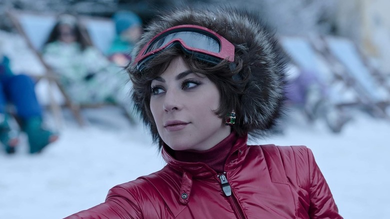 Patrizia standing in the snow in House of Gucci