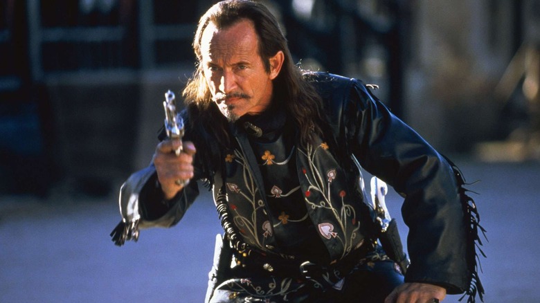 Ace Hanlon firing a gun in The Quick and the Dead