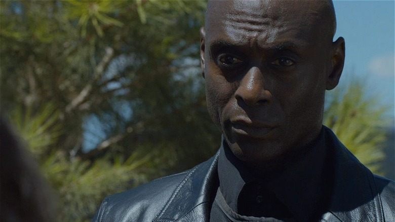 Reddick looking serious in leather jacket in The Guest