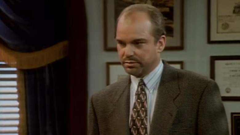 Billy Bob Thornton's Billy Bob Davis stands in an office in Hearts Afire