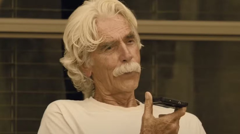 T.L. Norris (Sam Elliott) holding a cell phone on 