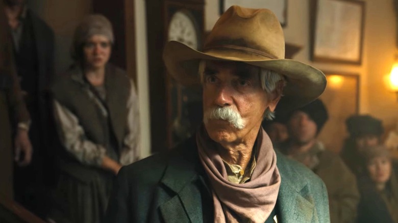 Sam Elliott as Shea Brennan standing in front of a crowd in 1883