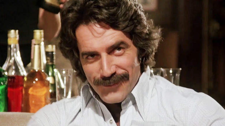 Sam Elliott's Pete Danner smiles in closeup as he sits on a couch in The Legacy