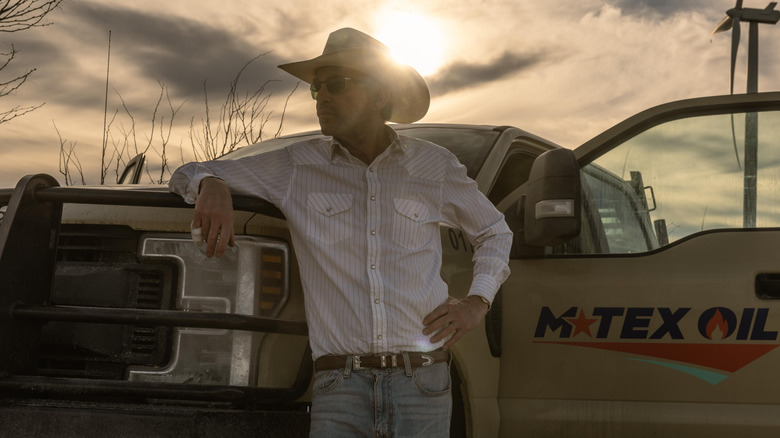 Billy Bob Thornton as Tommy Norris leaning up against his truck in Landman