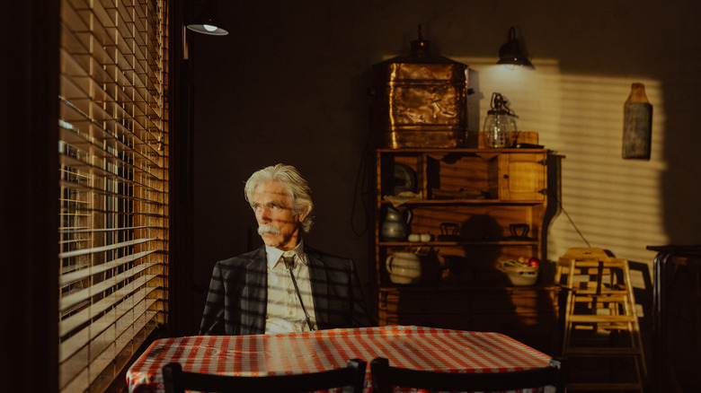 Sam Elliott's T.L. Norris sits in a restaurant looking out a window in Landman