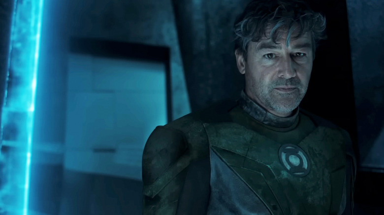Kyle Chandler's Hal Jordan stands in a dark room wearing his Green Lantern suit in Lanterns