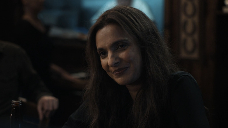 Poorna Jagannathan's Zoe Macon sits at a bar in Lanterns