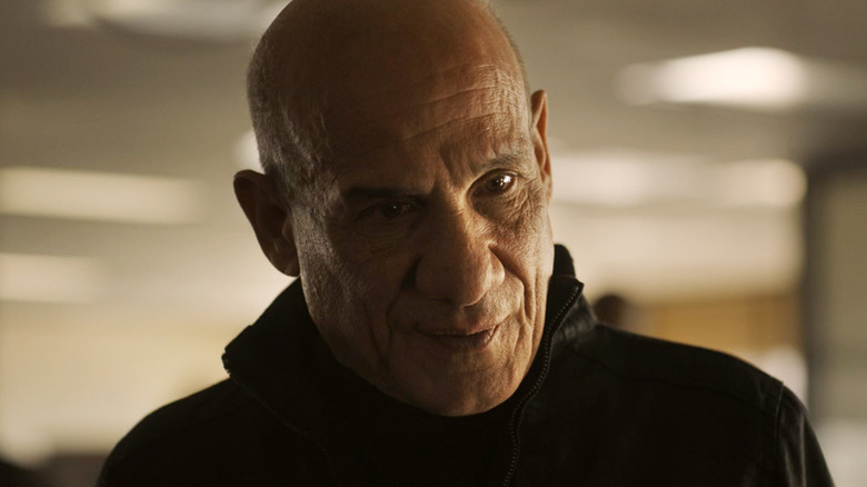 Paul Ben-Victor's Antaan is seen in closeup as he stands in an office in Lanterns