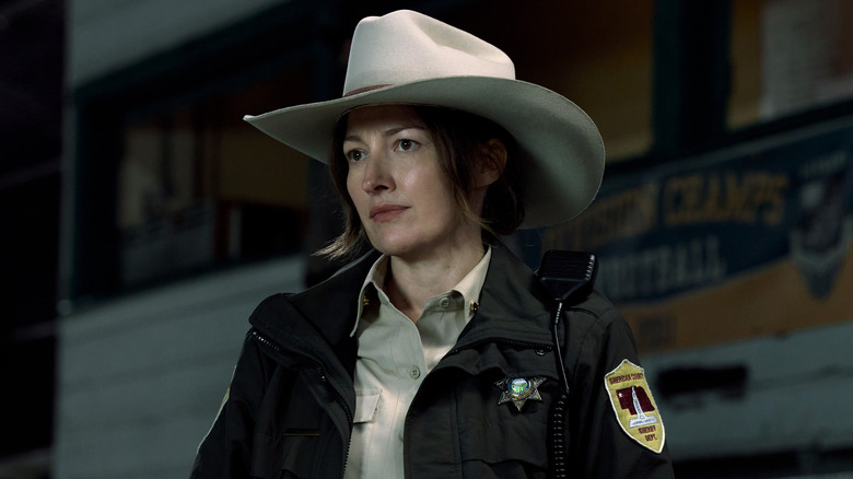 Kelly Macdonald as Sheriff Kerry Kane standing on the bleachers in Lanterns