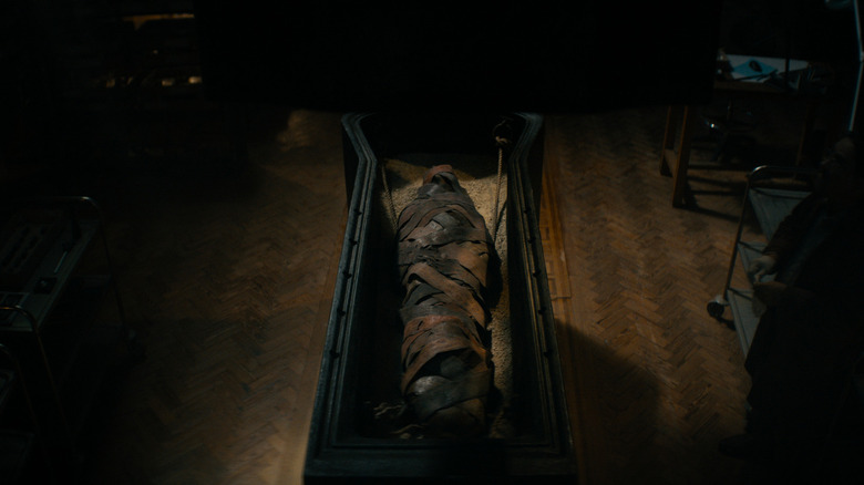 An open sarcophagus in the middle of the room in Lee Cronin's The Mummy