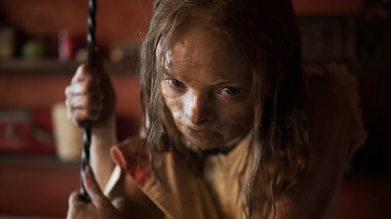 Natalie Grace as Katie clutching a metal bar in Lee Cronin's The Mummy