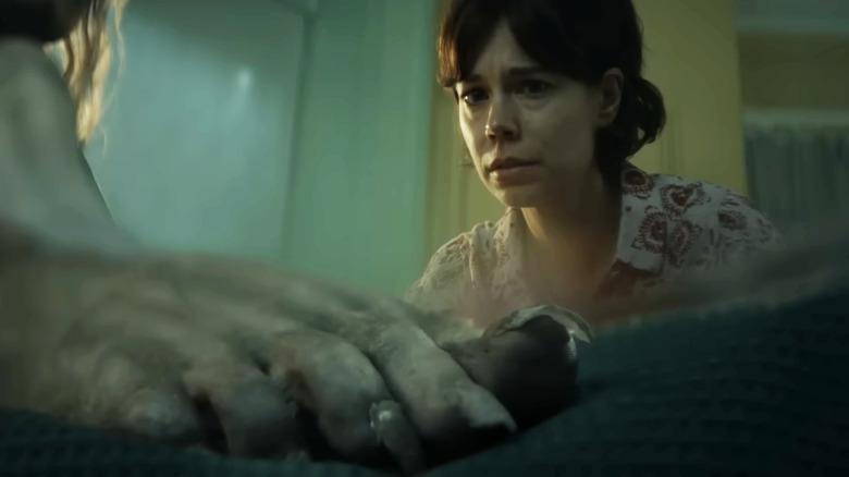 Larissa looking at Katie's foot in Lee Cronin's The Mummy