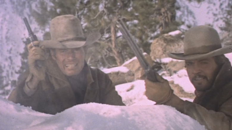 Charlton Heston's Will Penny and Lee Majors' Blue fire from behind some rocks in Will Penny