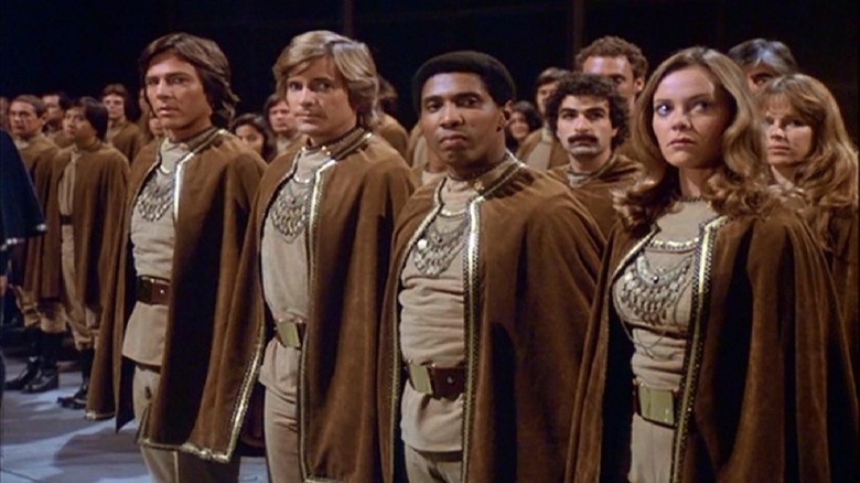 Four people in brown cloaks lined up in Battlestar Galactica