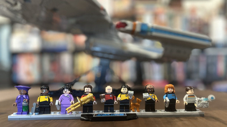 Close-up of the Star Trek LEGO Minifigs, with the Enterprise in the background