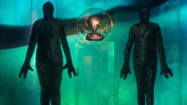 The Martian supreme intelligence is seen between two humanoid aliens in Invaders from Mars