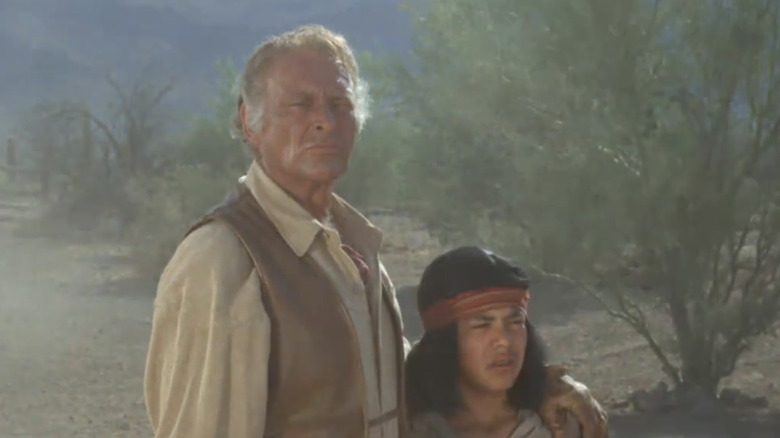 Leif Erickson's "Big John" Cannon stands beside a Native American boy in The High Chaparral
