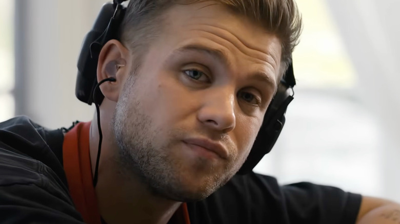 Leo Woodall as Niki White wearing headphones in Tuner