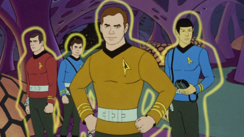 Scotty, McCoy, Kirk et Spock entourés de champs de force personnels dans Star Trek : la série animée