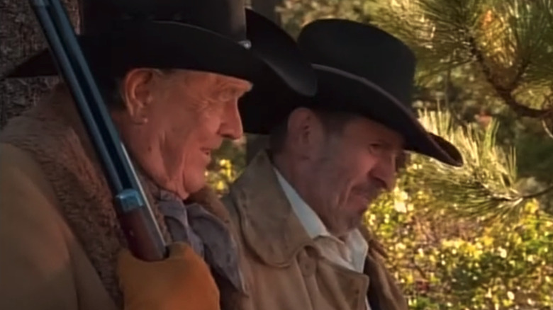 Ben Johnson's Bronc Evans sits beside Leonard Nimoy's Frank James in Bonanza: Under Attack