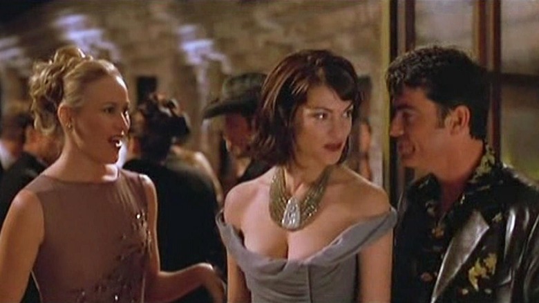 A blonde woman, Lenina, and Bernard hobnobbing at a party in Brave New World