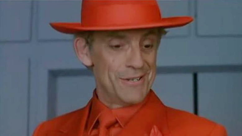 The Jackal wearing an orange suit and hat in Deadly Games