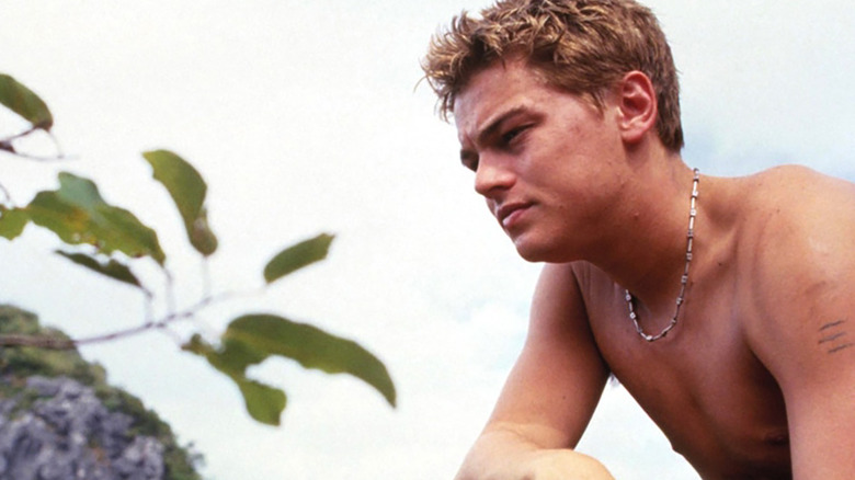 Leonardo DiCaprio looking at a tree in The Beach