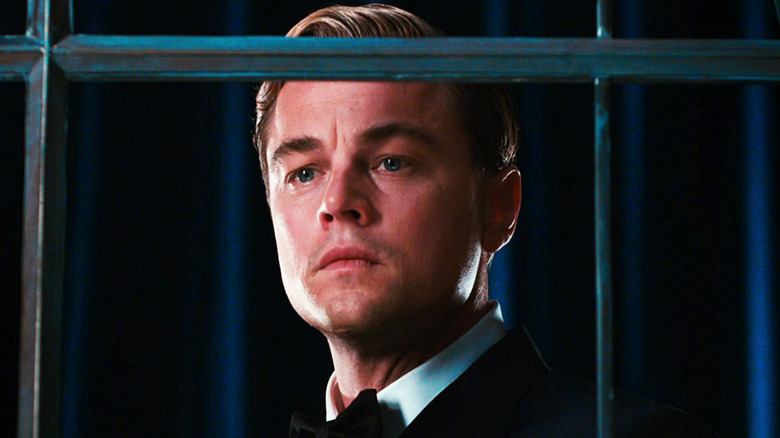 Leonardo DiCaprio's Jay Gatsby looks longingly out of a window in The Great Gatsby