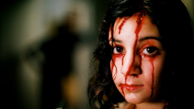 Eli covered in blood from Let the Right One In