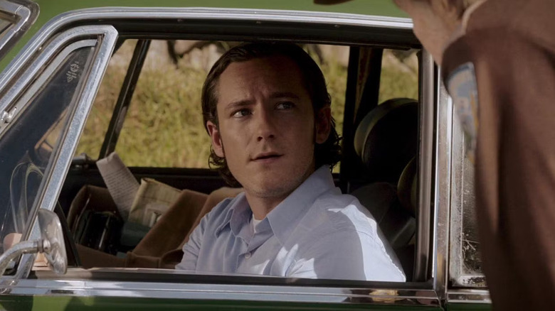 Lewis Pullman as Todd, sitting in a card in The Line