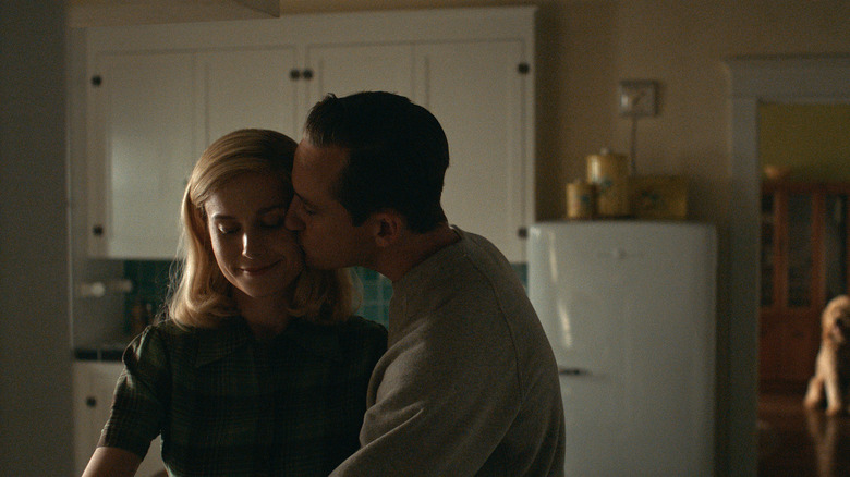 Calvin kissing Elizabeth on the cheek in their kitchen in Lessons in Chemistry