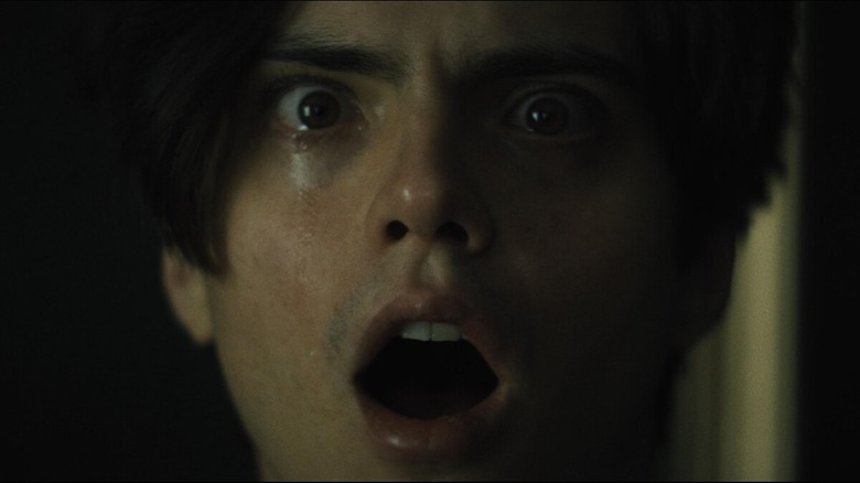 a man crying and looking ahead shocked 
