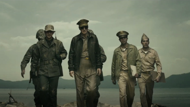 Liam Neeson as General Douglas MacArthur leads a small group of soldiers in Operation Chromite
