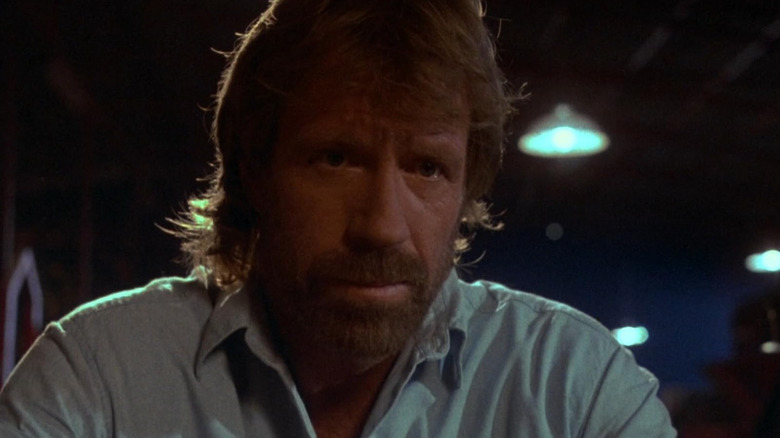 Chuck Norris as Major Scott McCoy looking somber in The Delta Force