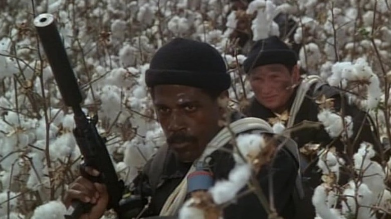 Liam Neeson as an uncredited Delta Force member hangs back behind Steve James as Bobby Lee in The Delta Force