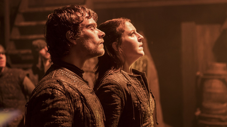 Theon and Yara Greyjoy stand side by side aboard a ship on Game of Thrones.