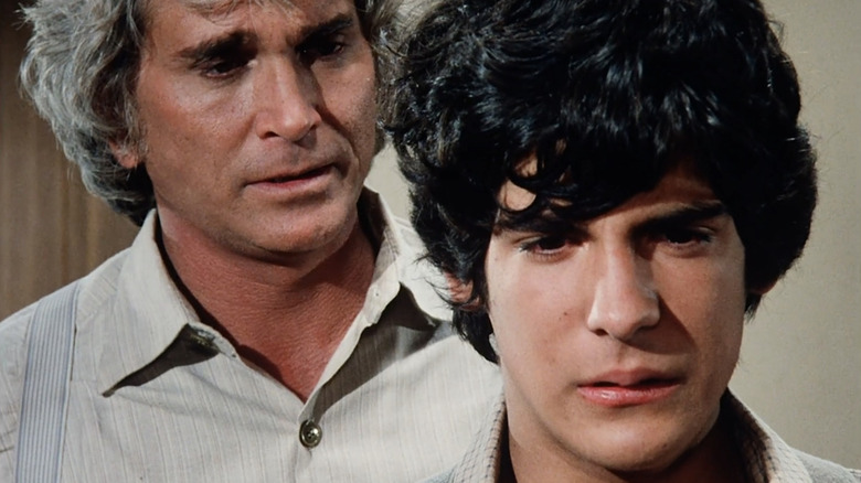 Michael Landon's Charles Ingalls stands behind Matthew Labyorteaux's Albert in Little House on the Prairie