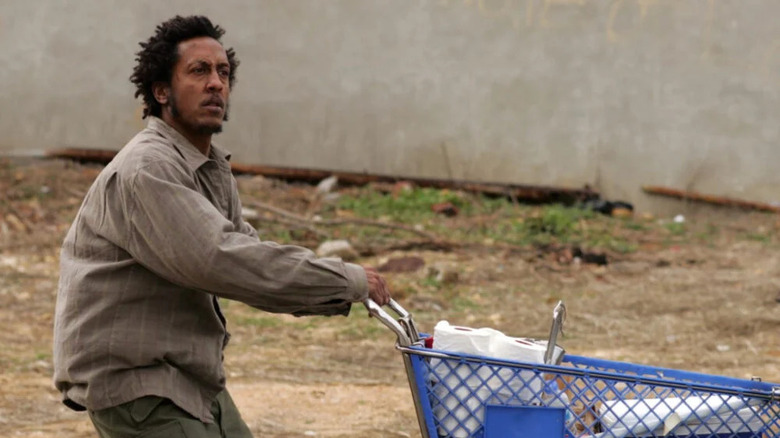 Reginald "Bubbles" Cousins (Andre Royo) pushes a shopping cart of supplies in "The Wire"