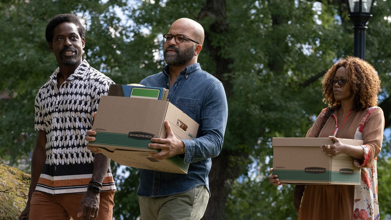 Sterling K. Brown as Cliff Ellison, Jeffrey Wright as Monk Ellison, and Erika Alexander as Coraline moving boxes in American Fiction.