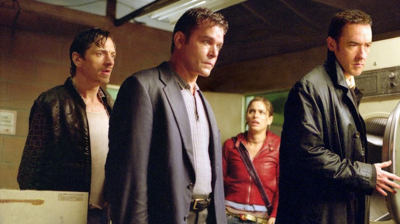 Larry, Samuel, Paris, and Ed in a laundry room in Identity