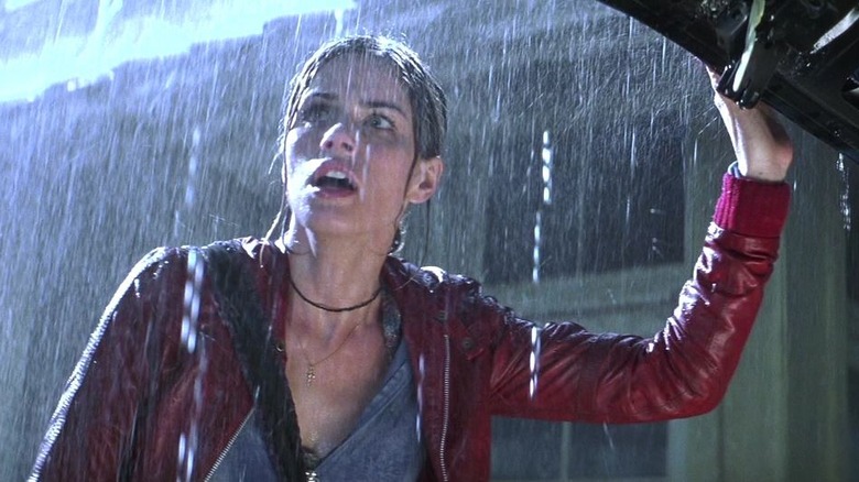 Paris outside in the rain next to an open trunk in Identity