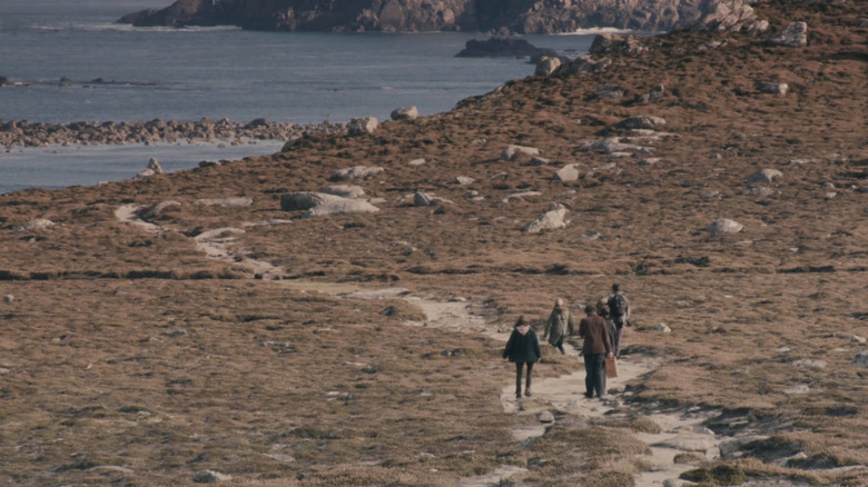 A family walks through a natural landscape by the water in Archipelago