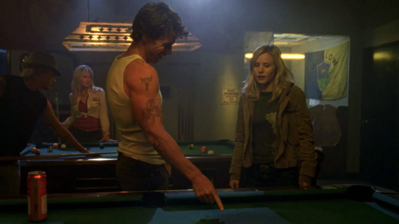 taylor Sheridan's Danny Boyd shows Kristen Bell's Veronica Mars a patch of blood on a pool table in a bar in Veronica Mars