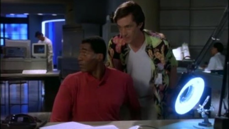 Dr. Miles Hawkins and John in a lab in M.A.N.T.I.S.