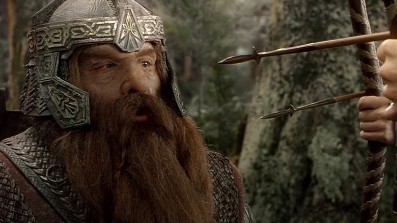 Gimli (John Rhys-Davies) stares at two arrows aimed at him in The Lord of the Rings: The Fellowship of the Ring