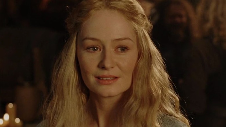 Éowyn (Miranda Otto) smiles warmly in a banquet hall in The Lord of the Rings: The Return of the King